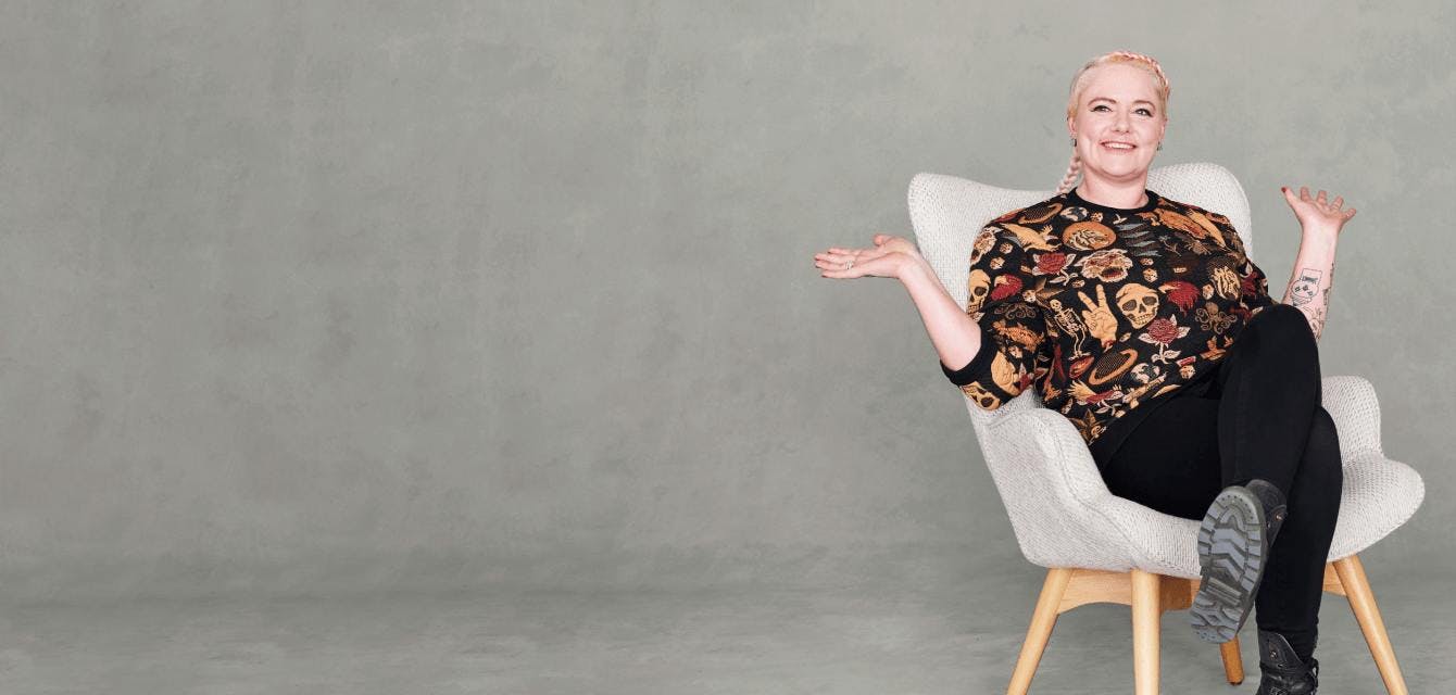 Woman sitting on a chair gesturing with arms